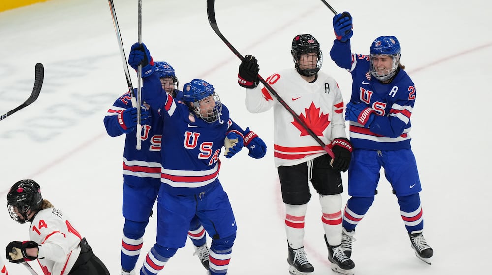 United States' Hilary Knight, center, celebrates after scoring a goal against Canada during the third period of the women's ice hockey gold medal game at the 2026 Winter Olympics, in Milan, Italy, Thursday, Feb. 19, 2026. (AP Photo/Carolyn Kaster)