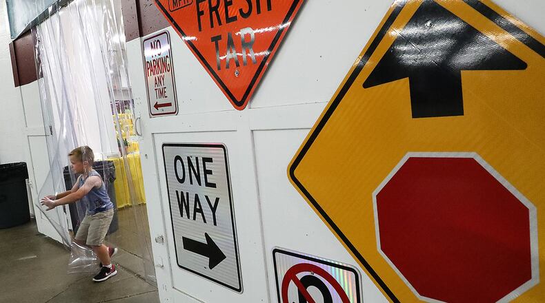 Charlie Kushmaul, 5, runs back and forth from the cool, air-conditioned Annex Building to the non-air conditioned Arts and Crafts Building Wednesday at the Clark County Fair. BILL LACKEY/STAFF