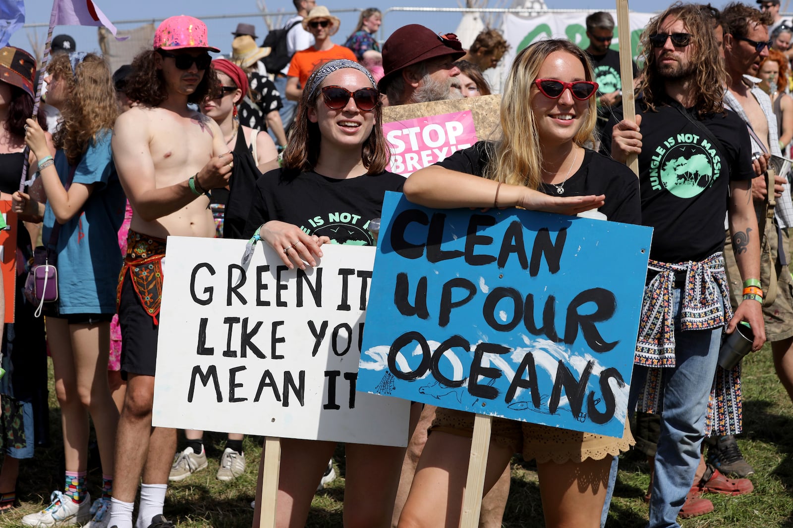 FILE - Protestors march to raise awareness of climate change and ecology on the second day of the Glastonbury Festival at Worthy Farm, Somerset, England, June 27, 2019. (Photo by Grant Pollard/Invision/AP, file)