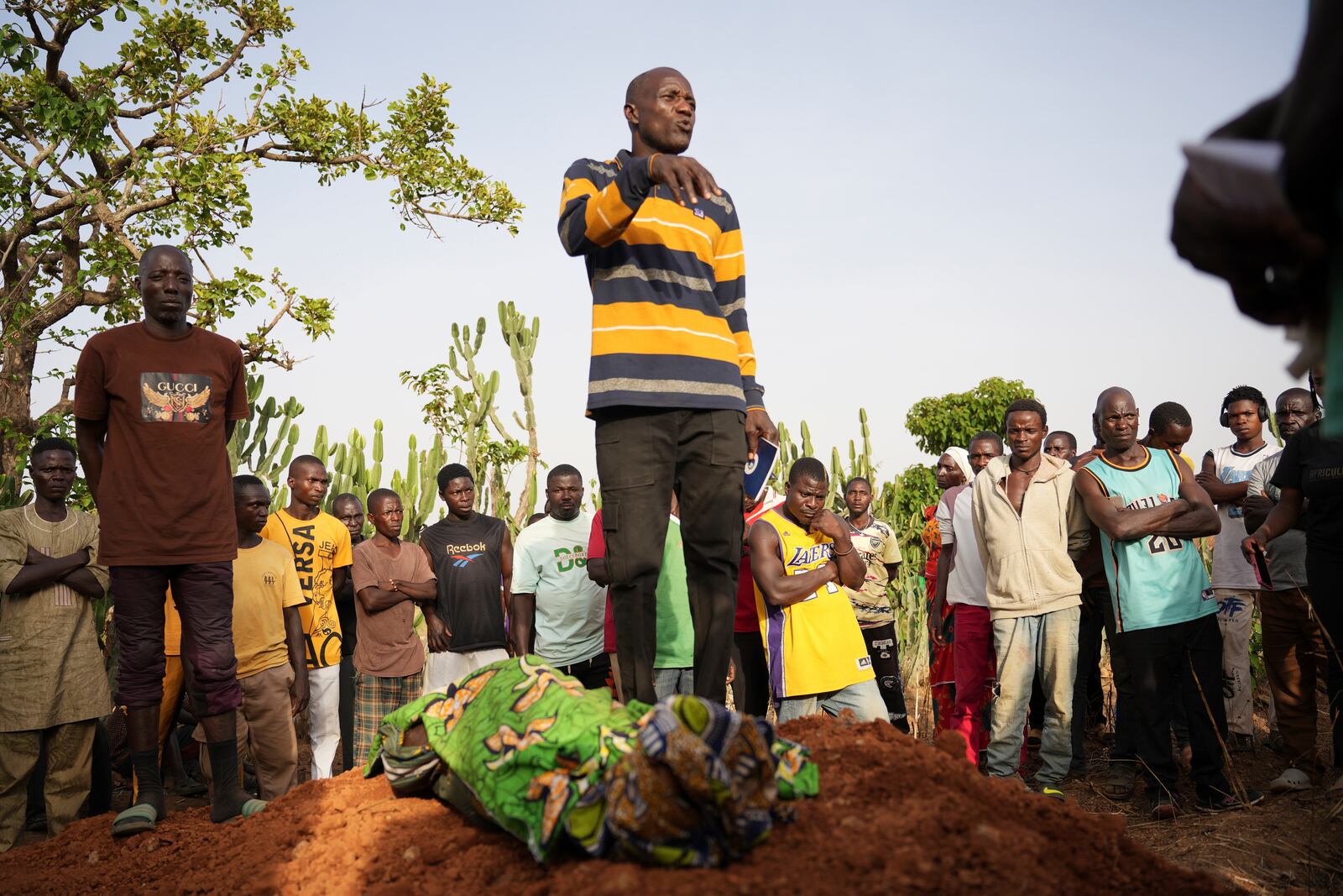 People attend the funeral of a man that was killed following an attack by gunmen in the Zike farming community in north-central Nigeria, Tuesday, April 15, 2025. (AP Photo/Samson Omale)
