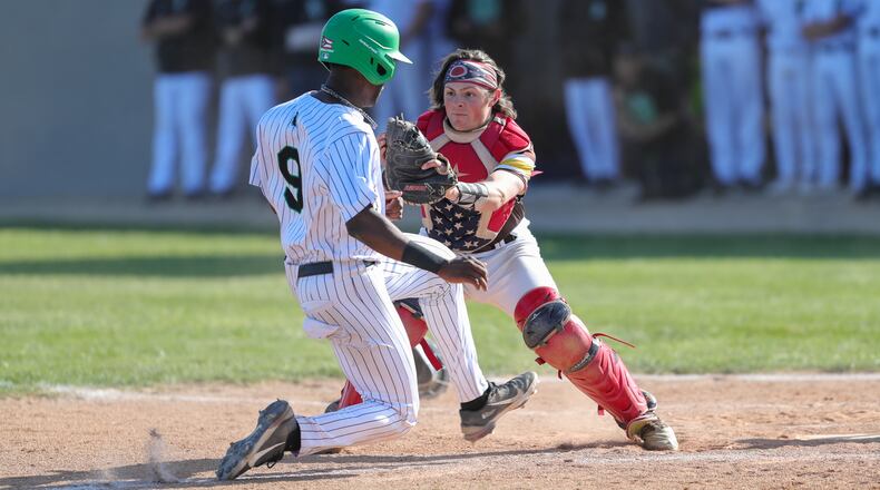 Kenton Ridge High School senior catcher Keller Fultz tags out Hamilton Badin senior Rodney Rachel at the plate during their Division II district final game on Thursday evening at Arcanum High School. The Rams won 10-0 in five innings. CONTRIBUTED PHOTO BY MICHAEL COOPER