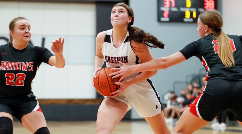 Greenon High School Claire Henry drives through ball through Tecumseh's Gabrielle Russell (right) and Emma Garber during their game earlier this season in Enon. Michael cooper/CONTRIBUTED