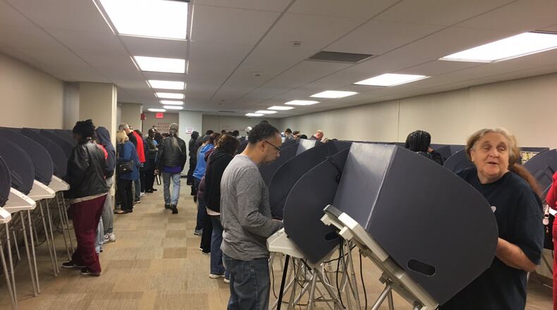 Ohio Secretary of State Jon Husted is calling for state legislators to spend $118 million replacing voting machines in Ohio’s 88 counties. Here early voters cast their ballots on electronic voting machines at the Montgomery County Board of Elections in 2016 . LYNN HULSEY/staff writer