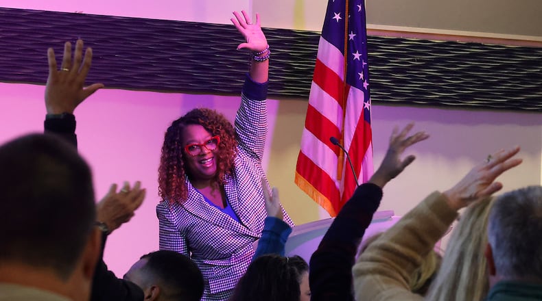 Terra Fox Williams, president and CEO of YWCA Dayton, encourages the crowd to stand up and stretch at the begining of her keynote speach at the annual Dr. Martin Luther King Luncheon Friday, Jan. 12, 2024 at the Hollenbeck Bayley Conference Center. BILL LACKEY/STAFF