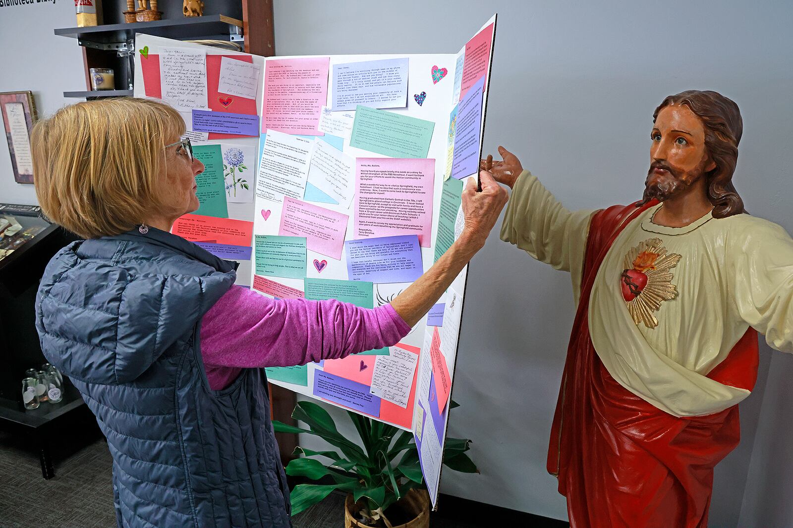 Connie Kearns looks over some of the letters of support St. Vincent DePaul in Springfield has received from people around the world Tuesday, Nov. 12, 2024. BILL LACKEY/STAFF