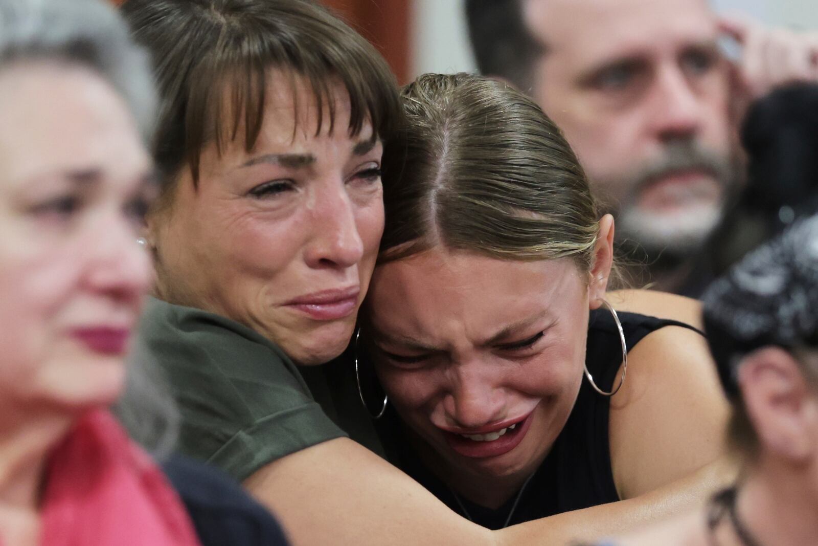 Dylan Mortensen gets a hug after speaking at the sentencing hearing of Bryan Kohberger at the Ada County Courthouse, for his sentencing hearing, Wednesday, July 23, 2025, in Boise, Idaho, for brutally stabbing four University of Idaho students to death nearly three years ago. (AP Photo/Kyle Green, Pool)