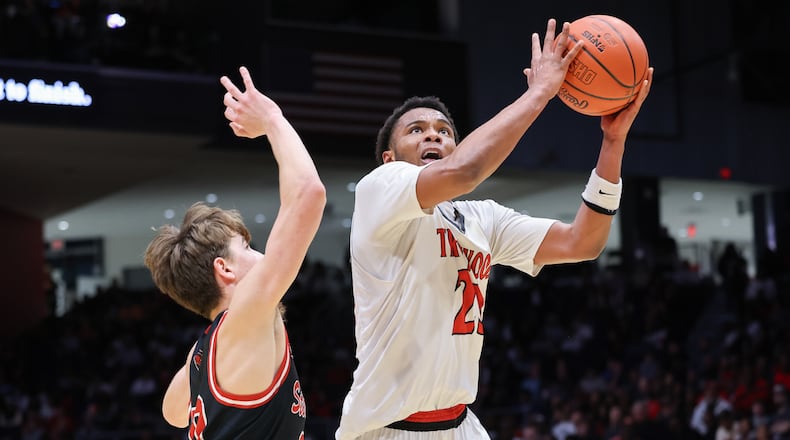 Trotwood-Madison junior guard Darius Dennis shoots with pressure from Steubenville's Landon Bowers during the Division III state final on Friday, March 20 at University of Dayton Arena. Dennis had nine points at halftime, when the Rams led 25-19. BRYANT BILLING / STAFF
