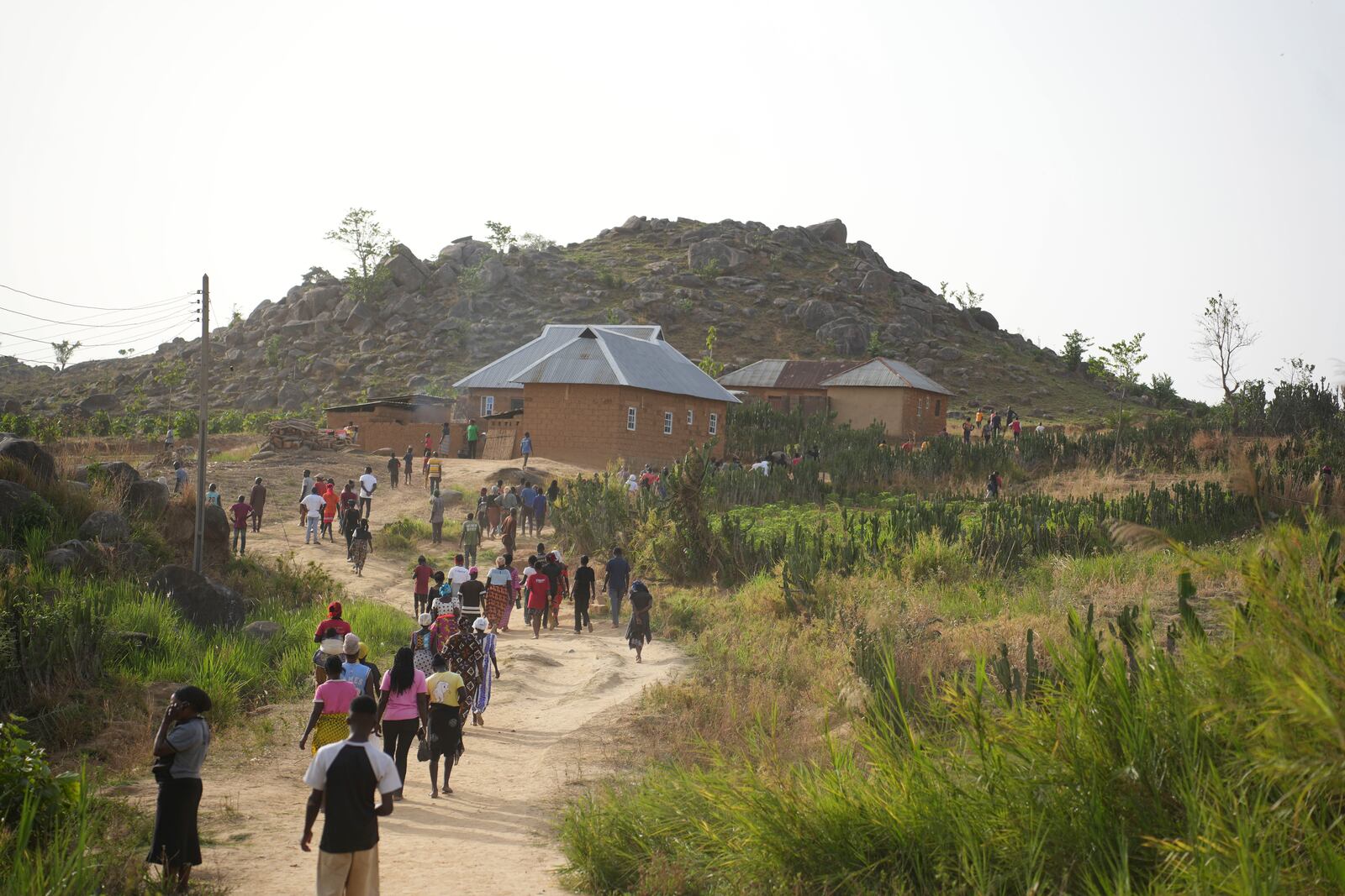 People prepare for the funeral of a man that was killed following an attack by gunmen in the Zike farming community in north-central Nigeria, Tuesday, April 15, 2025. (AP Photo/Samson Omale)