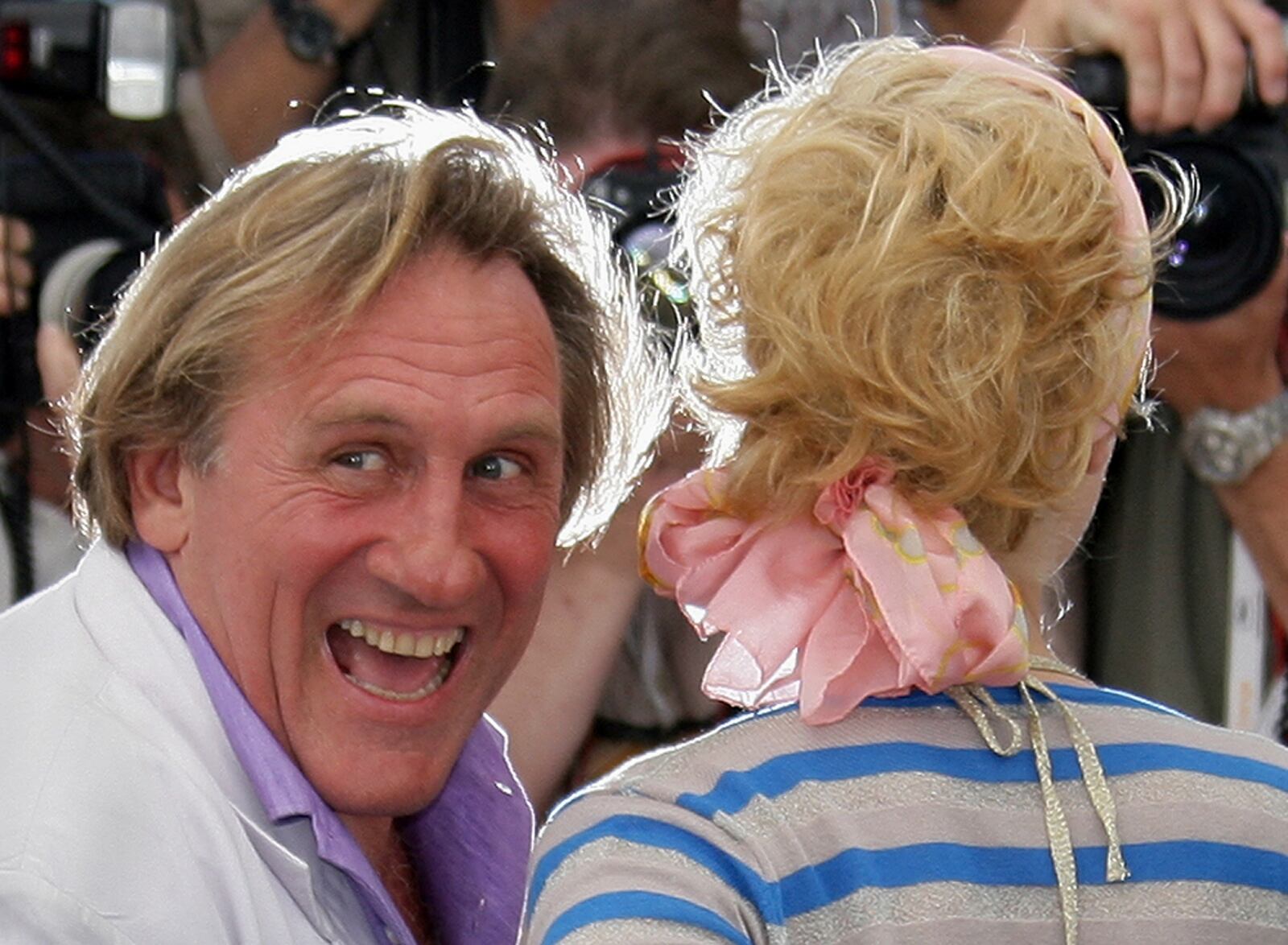 FILE - French actor Gerard Depardieu, left, and Belgian actress Cecile de France pose during a photo call for the film "Quand J'etais Chanteur," at the 59th International film festival in Cannes, southern France, on May 26, 2006. (AP Photo/Francois Mori, File)
