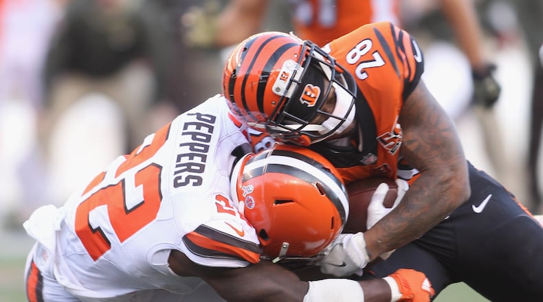 CINCINNATI, OH - NOVEMBER 26: Joe Mixon #28 of the Cincinnati Bengals runs the football upfield against Jabrill Peppers #22 of the Cleveland Browns during their game at Paul Brown Stadium on November 26, 2017 in Cincinnati, Ohio. The Bengals defeated the Browns 30-16. (Photo by John Grieshop/Getty Images)
