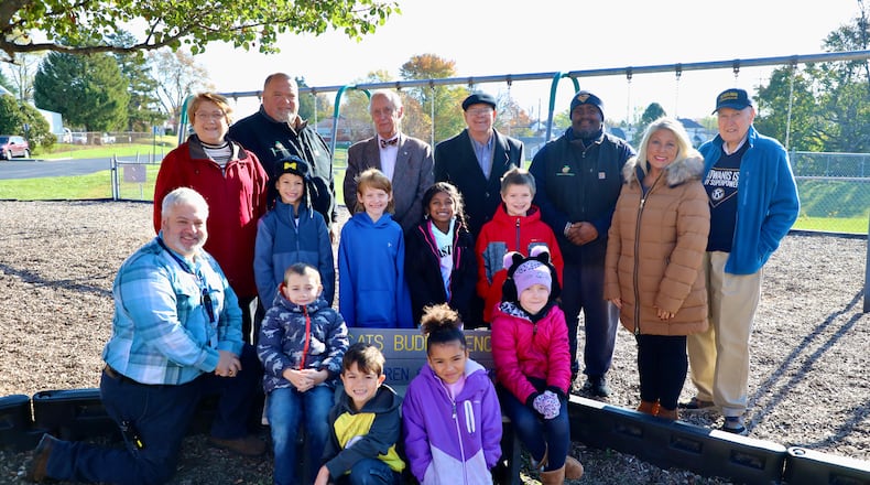 The Springfield City School District received 10 buddy benches that were donated from the Kiwanis Club of Springfield. They were placed on the playgrounds at each of the elementary schools, including Kenwood. In this photo (back row, from left to right) is Kenwood Elementary Principal Mike Wallace, Kiwanis Club President Susan Hillman, David Cook (Plastic Lumber Store), Kiwanis Representative Denis Driscoll, Kiwanis Representative Carl Patterson, Justin Johnson (Plastic Lumber Store). Springfield Local School District's Director of Communications Cherie Moore and Kiwanis Representative Dick Rice. Contributed