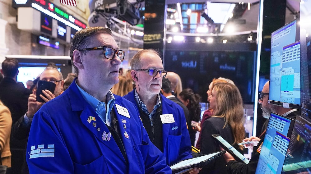 Specialist Patrick King, left, and trader Mark Puetzer work on the floor of the New York Stock Exchange, Wednesday, Jan. 28, 2026. (AP Photo/Richard Drew)