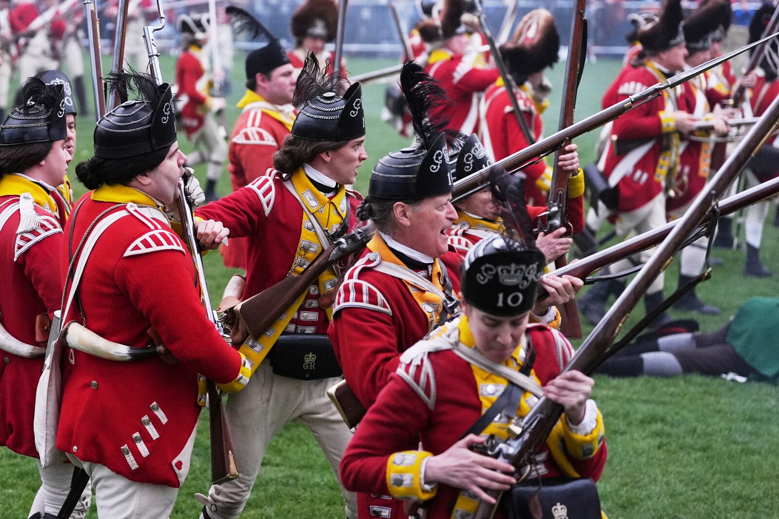 British Regulars fire on New England colonial militia, also known as a Minuteman, during a reenactment celebration of the 250th anniversary of the Battle of Lexington and start of the American Revolution, Saturday, April 19, 2025, in Lexington, Mass. (AP Photo/Charles Krupa)