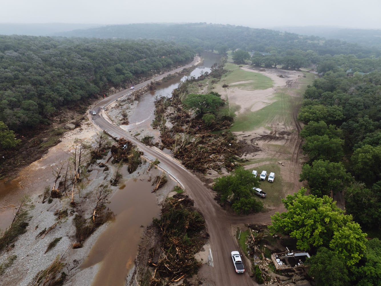 The flooded South Fork of the Guadalupe River near Camp Mystic, rear right, in Hunt, Texas, on Saturday, July 5, 2025. (Carter Johnston/The New York Times)