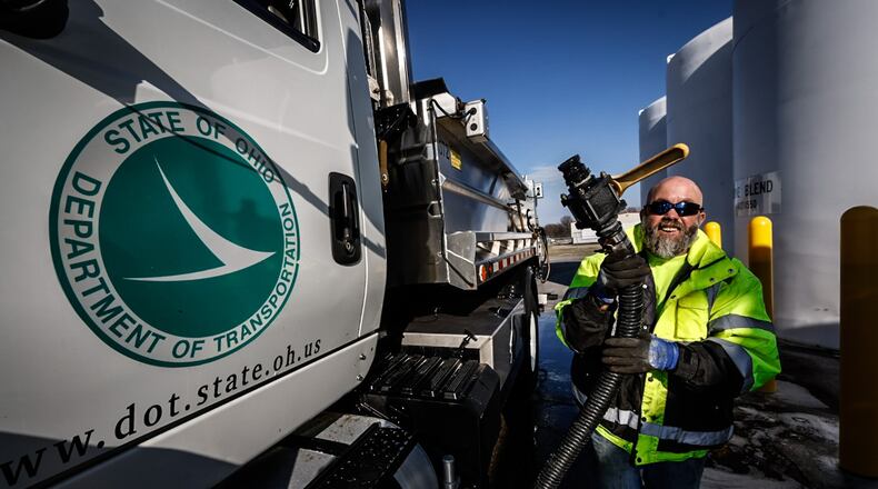 O.D.O.T. snowplow driver, Rob Gardner pumps an 80/20 brine mixture into his truck Tuesday December 20, 2022. ODOT road crews are readying their equipment for the winter weather heading to the Dayton area at the end of the week. JIM NOELKER/STAFF