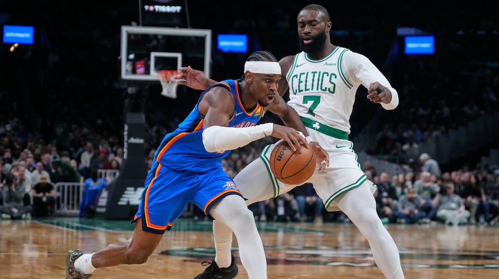 Oklahoma City Thunder guard Shai Gilgeous-Alexander, left, drives to the basket against Boston Celtics guard Jaylen Brown (7) during the first half of an NBA basketball game, Wednesday, March 25, 2026, in Boston. (AP Photo/Charles Krupa)