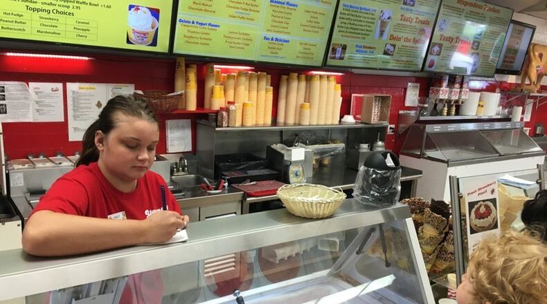 Emily Dyer of Springfield takes a customer order at Young s Jersey Dairy. KARA DRISCOLL/STAFF