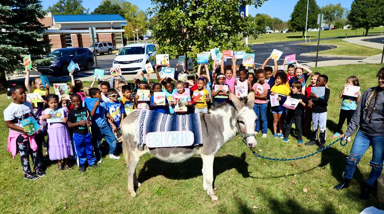 First grade students at Kenwood Elementary School in the Springfield City School District were visited last week by a donkey from a local farm as part of a language arts lesson. Contributed