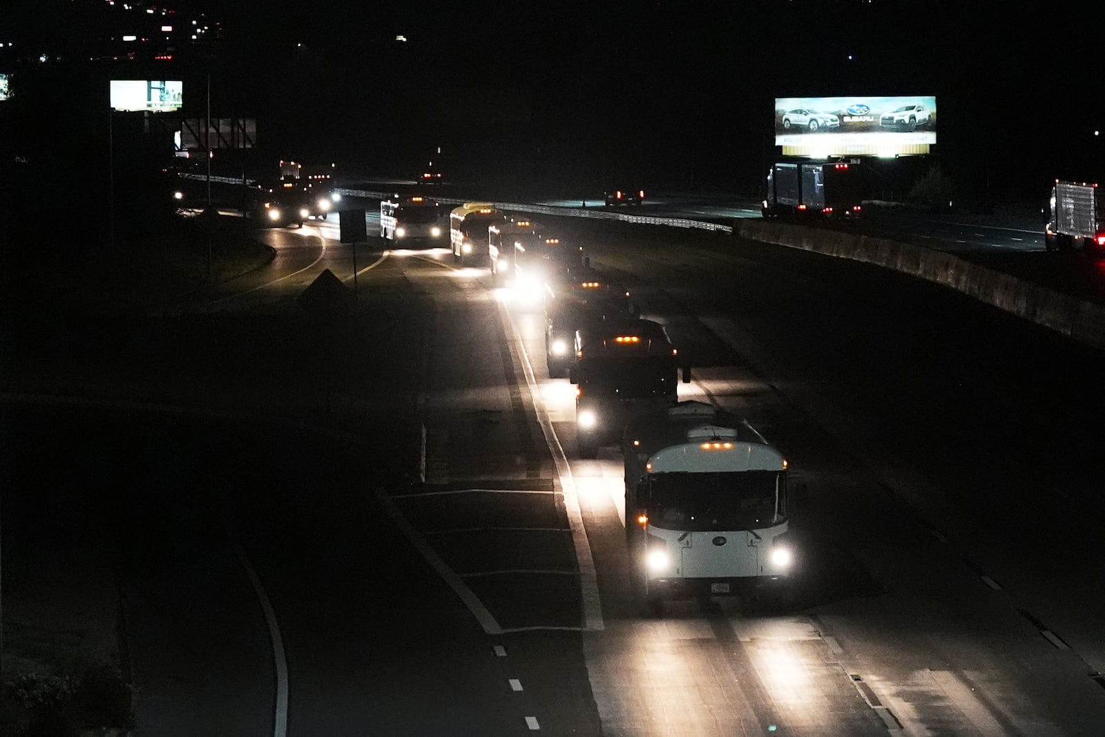 A convoy of buses moves along Interstate Highway 10 after leaving the Marine Corps base in Twentynine Palms, Calif, Monday, June 9, 2025, near Redlands, Calif. (AP Photo/Gregory Bull)