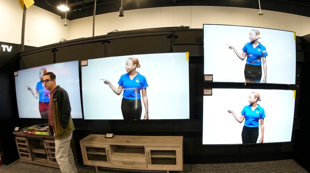 FILE - A customer turns away after looking at big-screen televisions on display in a Best Buy store, Nov. 21, 2023, in southeast Denver. (AP Photo/David Zalubowski, file)