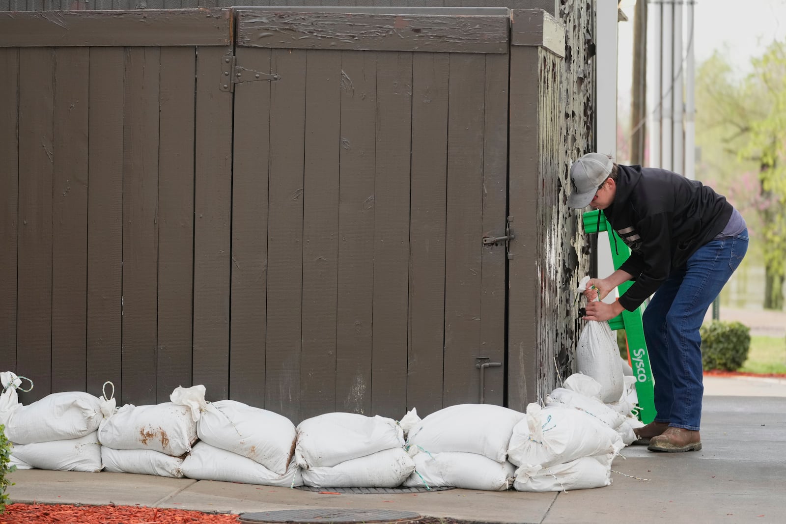 FILE - John Milt places sandbags in preparation for flooding near the banks of the Cumberland River in Clarksville Tenn., Friday, April 4, 2025. (AP Photo/George Walker IV, File)