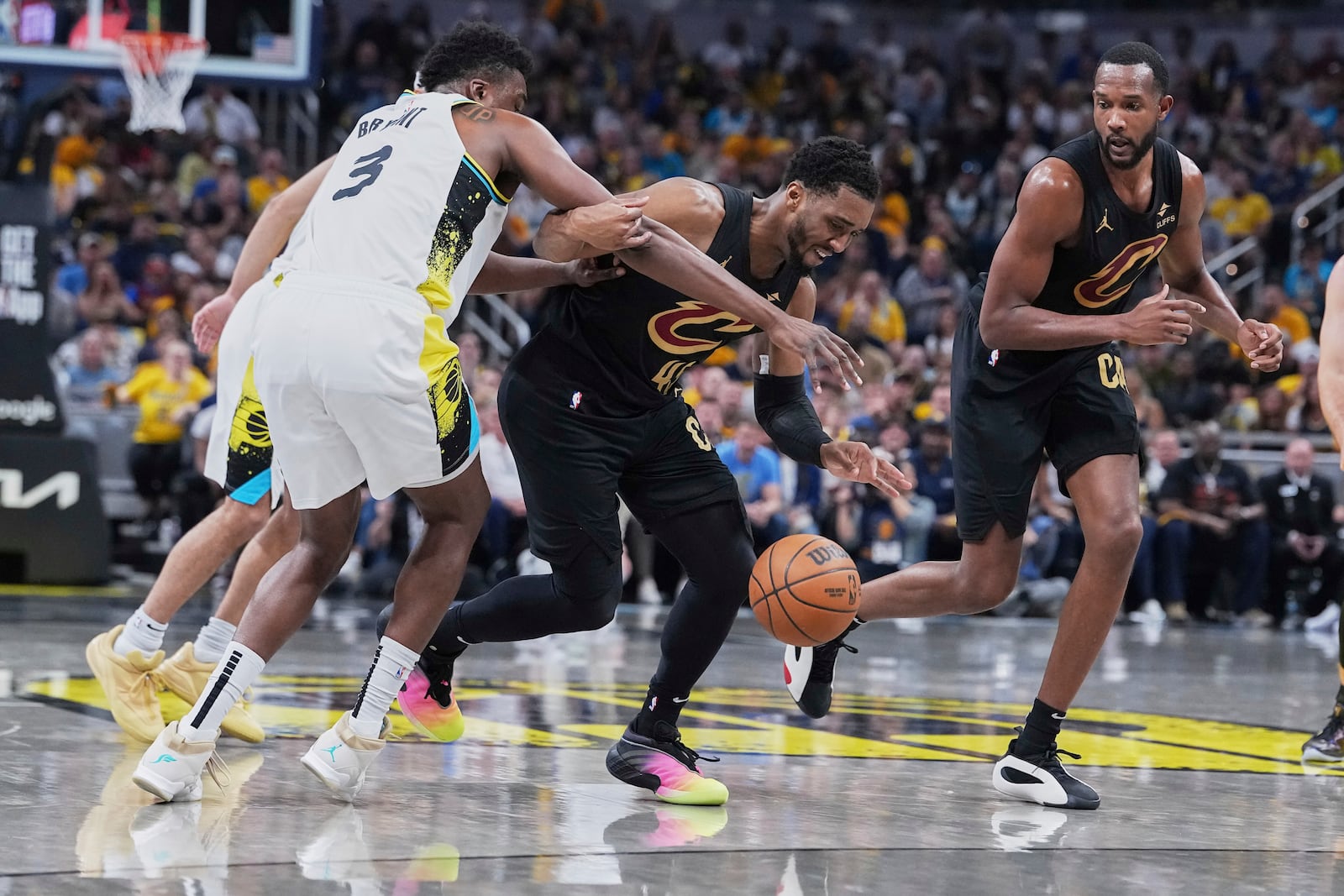 Cleveland Cavaliers guard Donovan Mitchell (45) chases down the ball against Indiana Pacers center Thomas Bryant (3) in the first half of Game 4 in the Eastern Conference semifinals of the NBA basketball playoffs in Indianapolis, Sunday, May 11, 2025. (AP Photo/Michael Conroy)
