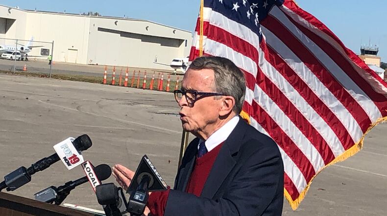 Gov. Mike DeWine flew into Lunken Airport in Cincinnati Friday afternoon to address the surge of coronavirus cases in the state, including counties in Southwest Ohio. RICK McCRABB/STAFF