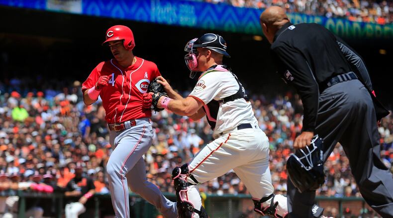 The Reds’ Jose Iglesias is tagged out at home by the Giants’ Erik Kratz during the first inning at Oracle Park on Sunday, May 12, 2019 in San Francisco, California. (Photo by Daniel Shirey/Getty Images)