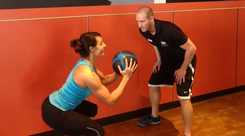 NATALIE BLOMMEL of Centerville gets a personal-training session from Nick Garrison of Centerville at the Urban Active fitness club at The Greene.