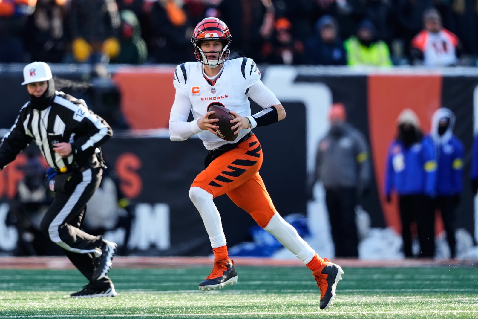 Cincinnati Bengals quarterback Joe Burrow (9) runs with the ball against the Baltimore Ravens during the first half of an NFL football game, Sunday, Dec. 14, 2025, in Cincinnati. (AP Photo/Carolyn Kaster)