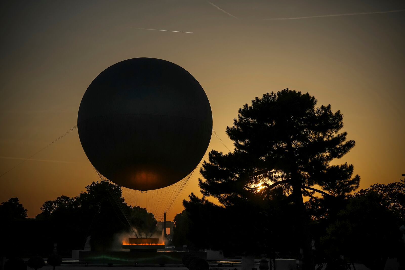 The helium ballon that was used during the 2024 Olympic Games as the Olympic cauldron is launched in the Tuileries Gardens of Paris on Saturday, June 21, 2025. (AP Photo/Aurelien Morissard)
