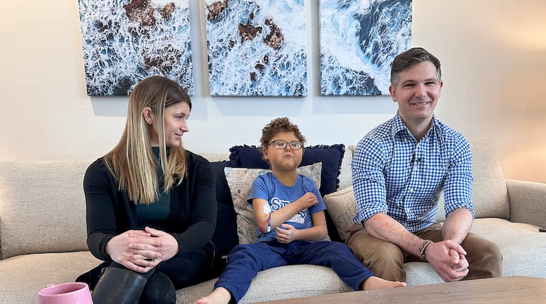 Logan Coyle, nine years old, center, answers questions during an interview with his parents Rebecca Coyle, left, and Logan Coyle, Feb. 10, 2026, in New York. (AP Photo/Phil Marcelo)