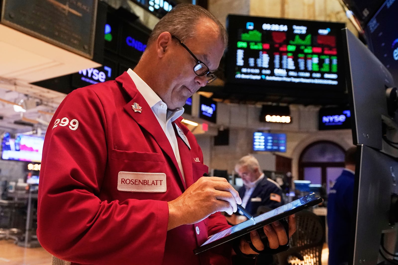 Trader William Lawrence works on the floor of the New York Stock Exchange, Tuesday, July 29, 2025. (AP Photo/Richard Drew)