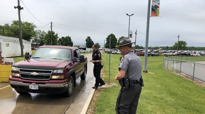Lt. Brett Bauer of the Springfield Police Department, left, and Lt. Brian Aller of the Ohio State Highway Patrol met motorists as part of the Click It or Ticket safety campaign kickoff at the Clark County Fairgrounds on Friday afternoon. Photo by Brett Turner