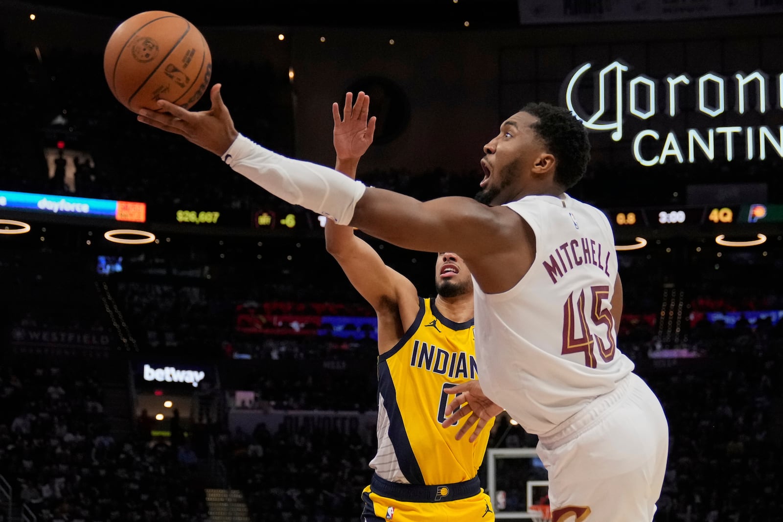 Cleveland Cavaliers guard Donovan Mitchell (45) goes to the basket past Indiana Pacers guard Tyrese Haliburton, left, in the second half during Game 1 in the Eastern Conference semifinals of the NBA basketball playoffs Sunday, May 4, 2025, in Cleveland. (AP Photo/Sue Ogrocki)