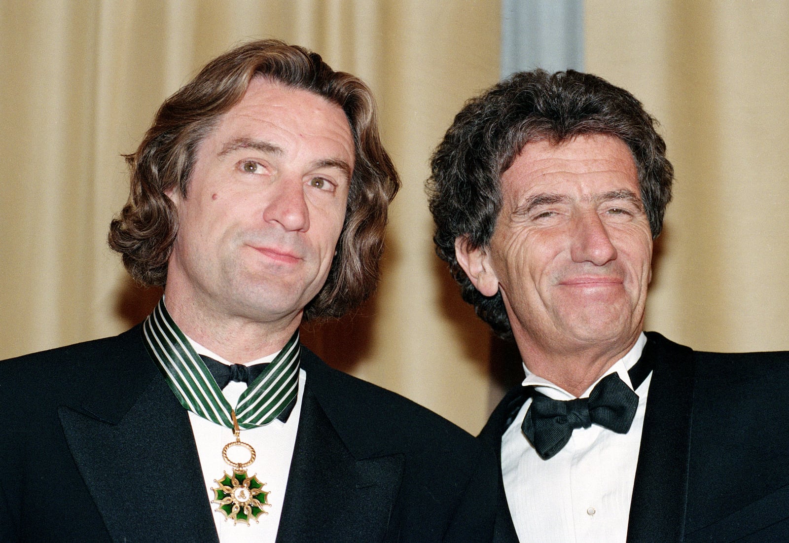 FILE - American actor Robert De Niro, left, appears with French Minister of Culture, Jack Lang, after receiving the French Medal of Art and Letters during the 44th Cannes Film Festival in Southern France on May 17, 1991. (AP Photo/Jose Goitia, File)