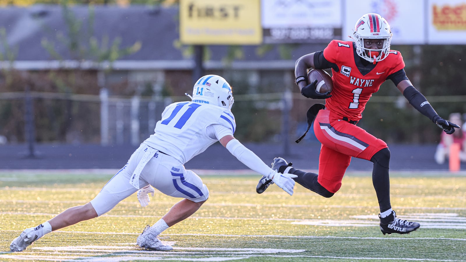 Wayne junior receiver Jamier Averette-Brown (right) tries to avoid Springboro's rice Markoff during a Greater Western Ohio Conference game on Friday, Sept. 12 at Heidkamp Stadium. Brown, an Ohio State recruit, had over 250 all-purpose yards and scored two touchdowns. BRYANT BILLING / STAFF