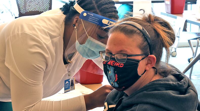 OhioMeansJobs Champaign County has partnered with Clark State College to help focus on rural healthcare programs. Here, Adalay Yearby, a nursing student at Clark State College, gave Amanda Kothman a COVID vaccine last year. BILL LACKEY/STAFF