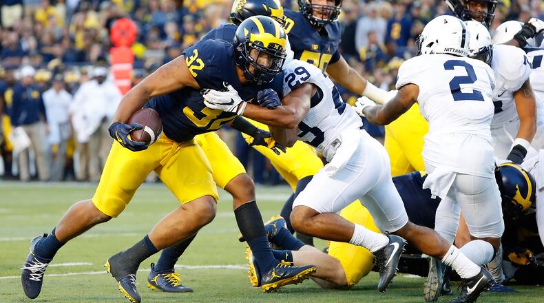 ANN ARBOR, MI - SEPTEMBER 24: Ty Isaac #32 of the Michigan Wolverines runs the ball in for a fourth quarter touchdown during the game against the Penn State Nittany Lions at Michigan Stadium on September 24, 2016 in Ann Arbor, Michigan. Michigan defeated Penn State 49-10. (Photo by Leon Halip/Getty Images)