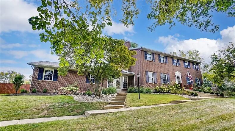 The front of the two-story home has an asphalt driveway with a turnaround and two concrete walkways leading to the front door and the entry to the breezeway. There is a two-car attached, side-entry garage with opener. Contributed photos