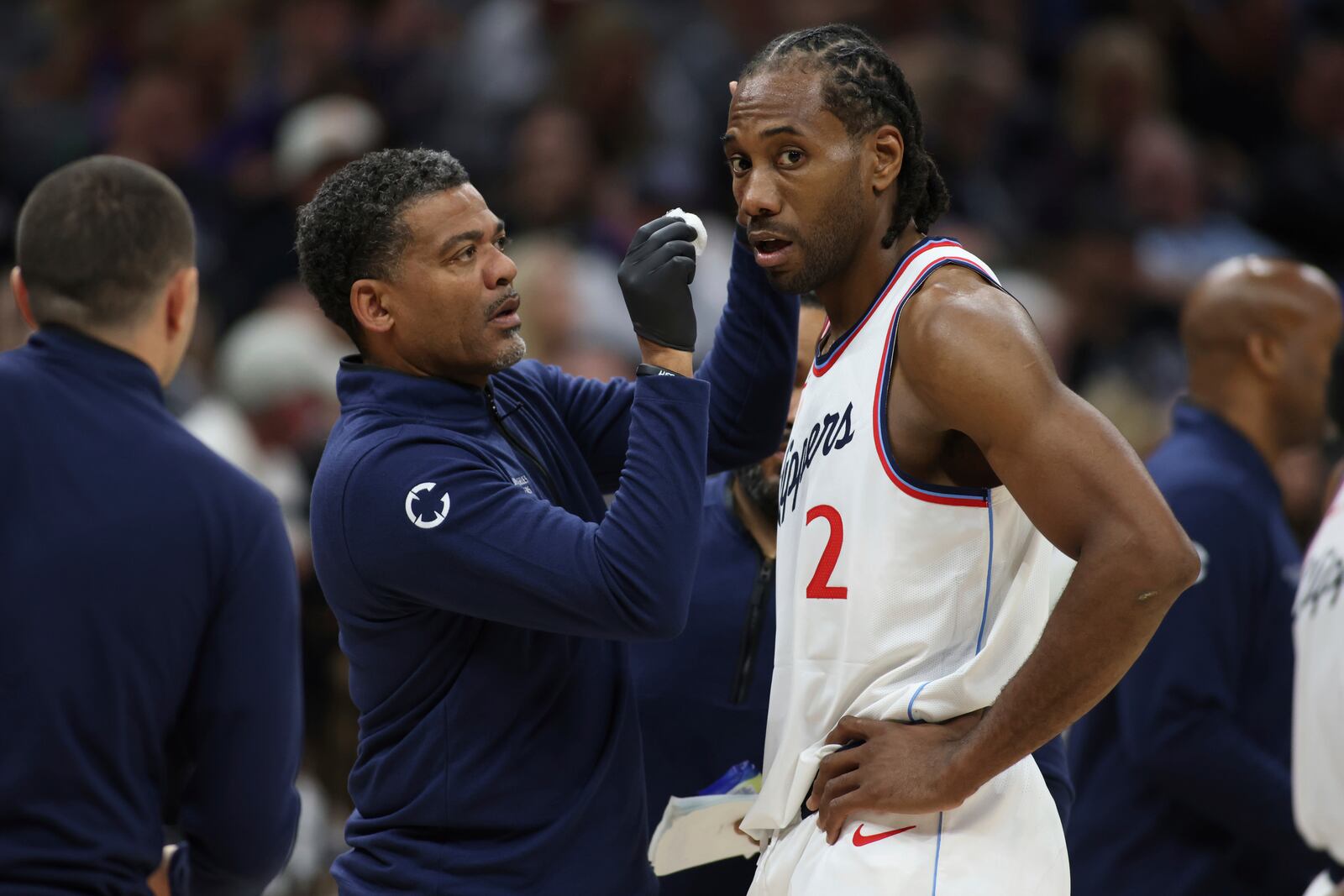 Los Angeles Clippers forward Kawhi Leonard (2) get looked at by the medics during second half of an NBA basketball game against theSacramento Kings, Friday, April 11, 2025, in Sacramento, Calif. (AP Photo/Scott Marshall)