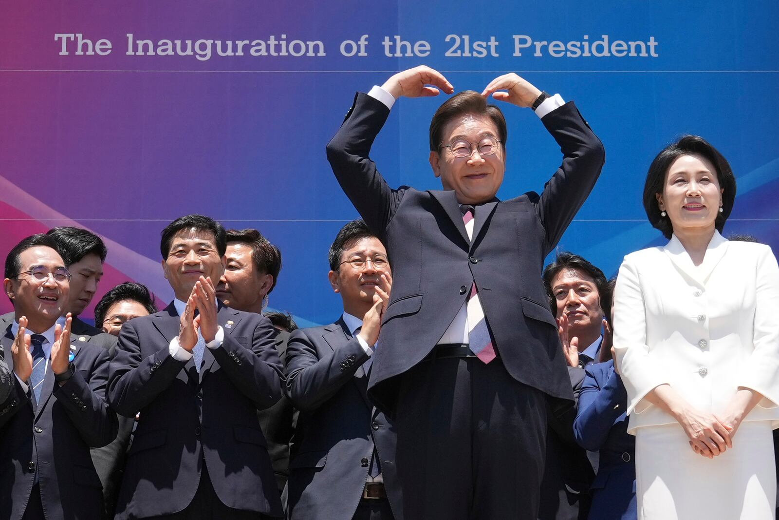 South Korean new President Lee Jae-myung, front left, and his wife Kim Hea Kyung greet to the people after attending the presidential inauguration at the National Assembly in Seoul, South Korea, Wednesday, June 4, 2025. (AP Photo/Lee Jin-man, Pool)