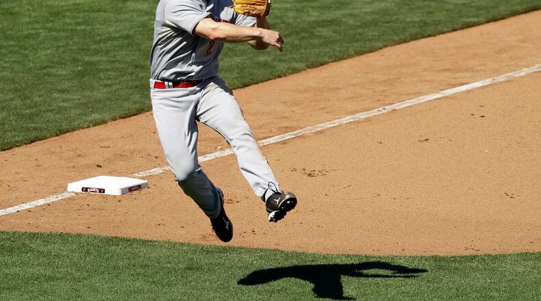 Cincinnati Reds third baseman Scott Rolen throws out San Francisco Giants’ Buster Posey during the seventh inning of a baseball game in San Francisco, Wednesday, Aug. 25, 2010. (AP Photo/Marcio Jose Sanchez)