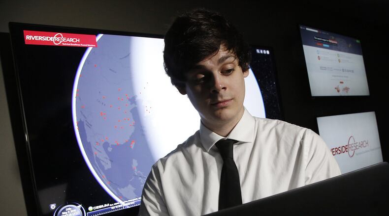 Cyber Technician Mike Conacher works a Cyber Threat Map the shows the location of computers that are trying to probe the portals of his employer, Riverside Research, in Beavercreek. TY GREENLEES / STAFF