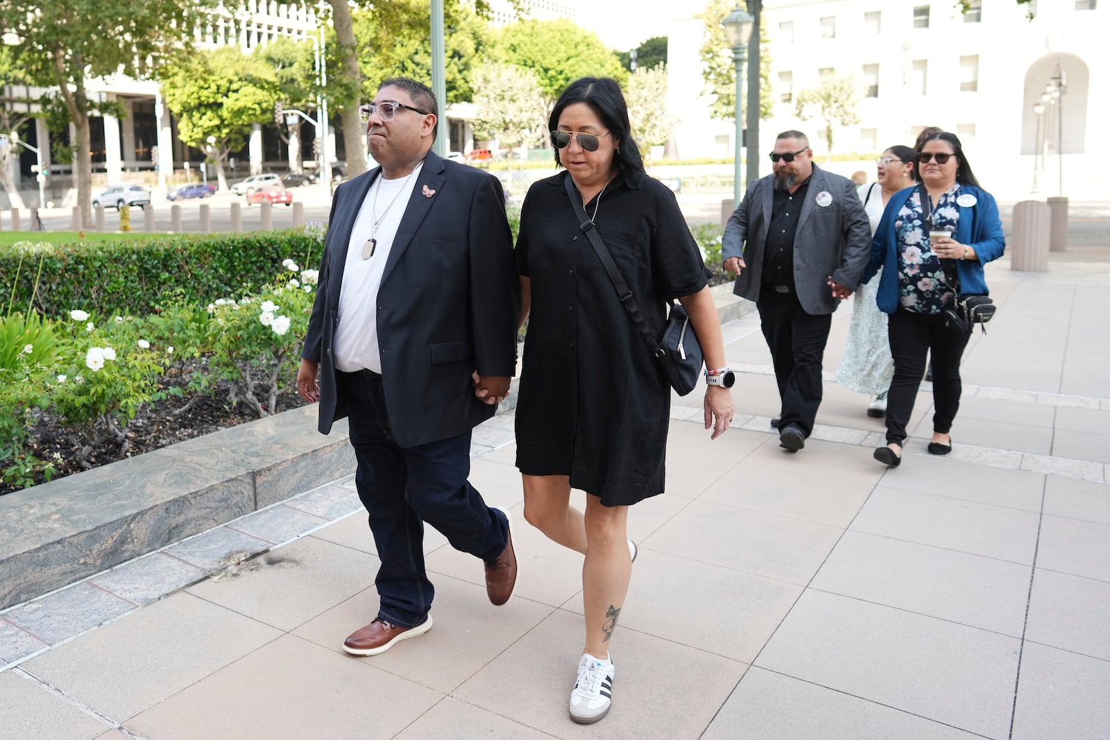 From left to right, Jerry Mata, Veronica Mata, Javier Cazares and Gloria Cazares arrive for a court hearing in a lawsuit between victims' families in the 2022 Uvalde, Texas school shooting and Meta Platforms on Friday, July 18, 2025, in Los Angeles. (AP Photo/Eric Thayer)