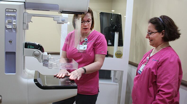 Selena Kemper (left) and Dawn Naill with Mercy Health Mobile Mammography inside the 3D mobile mammography vehicle. JEFF GUERINI/STAFF