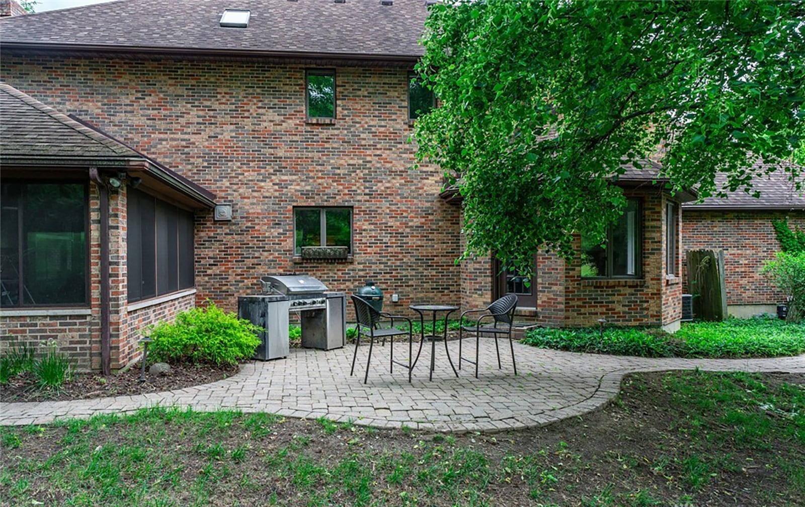 The rear of the home features a paver patio and walkways. The home is mostly brick with heavy woods surrounding it. CONTRIBUTED