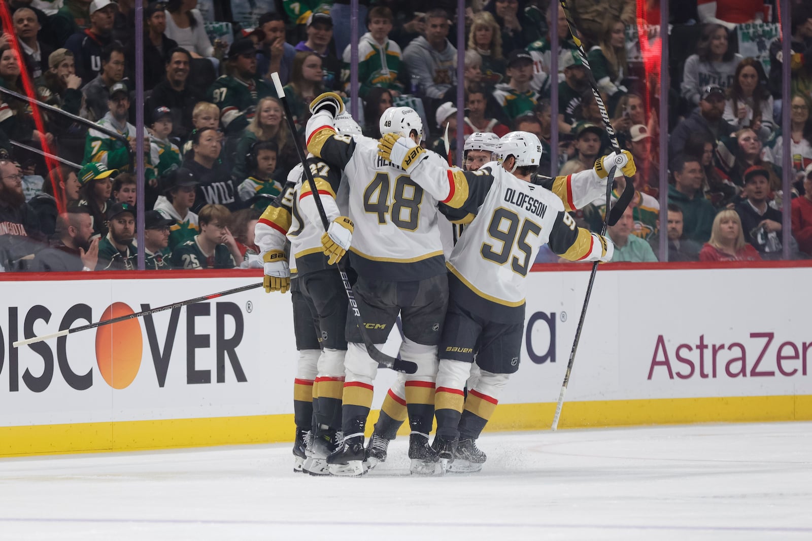 Vegas Golden Knights defenseman Shea Theodore (27) celebrates with teammates after scoring a power play goal during the first period of Game 6 of a first-round NHL hockey playoff series against the Minnesota Wild, Thursday, May 1, 2025, in St. Paul, Minn. (AP Photo/Bailey Hillesheim)