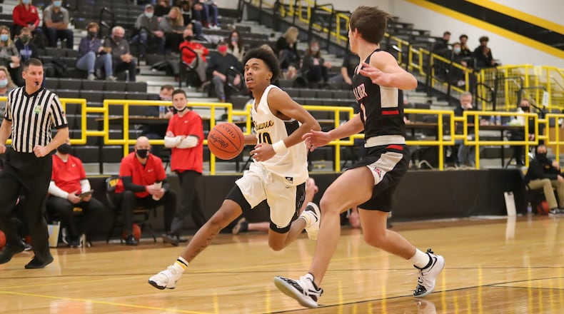 Cutline: Shawnee High School senior Jamon Miller drives past Jonathan Alder junior Grant Welsch during their game on Friday night in Springfield. The Pioneers won 45-44. Michael Cooper/CONTRIBUTED