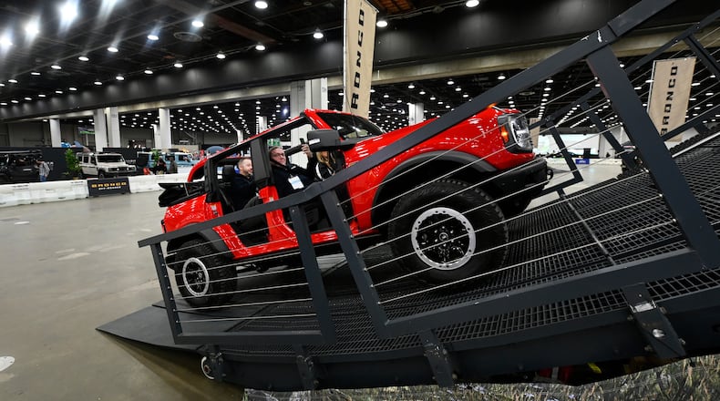 FILE - Guests are given a ride in a Bronco on a track at the Detroit Auto Show, Friday, Jan. 10, 2025, in Detroit. (AP Photo/Jose Juarez, file)